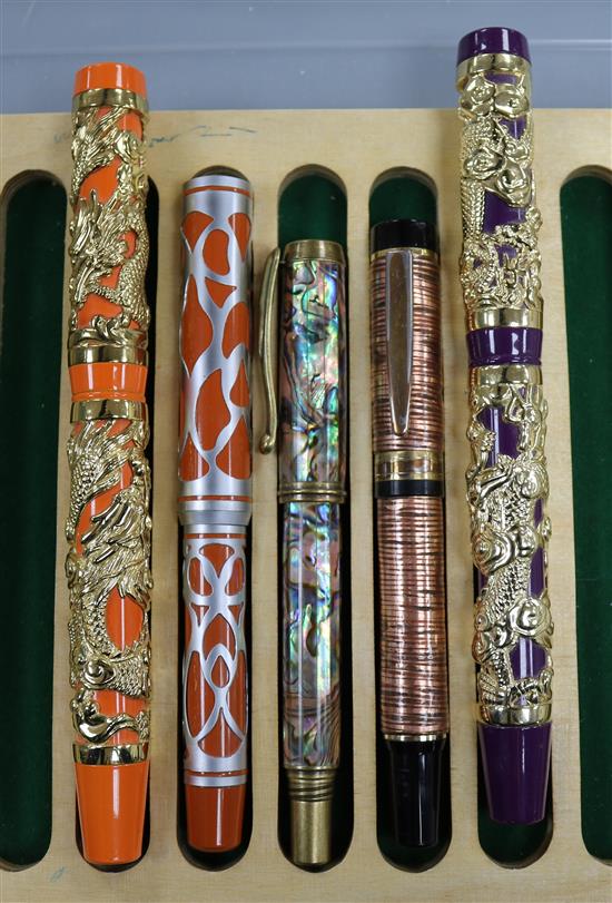 Three ornate fountain pens, cased